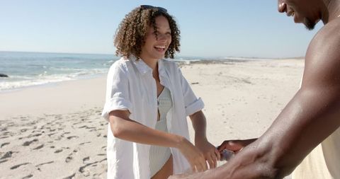 Couple Enjoys Carefree Beach Day with Laughter and Friendship
