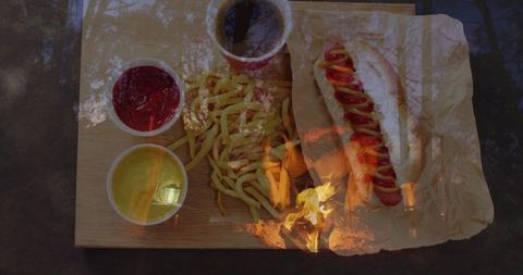Outdoor Feast with Classic Hot Dog and Crispy Fries on Wooden Board