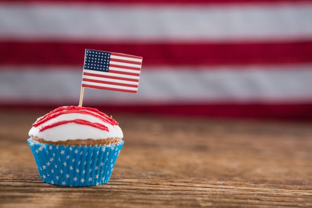 Patriotic Cupcake with American Flag on Wooden Table - Download Free Stock Photos Pikwizard.com