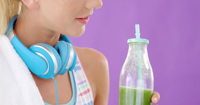 Active Woman Drinking Green Smoothie with Headphones - Download Free Stock Images Pikwizard.com