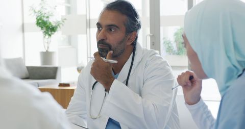 Medical team meeting with diverse doctors collaborating