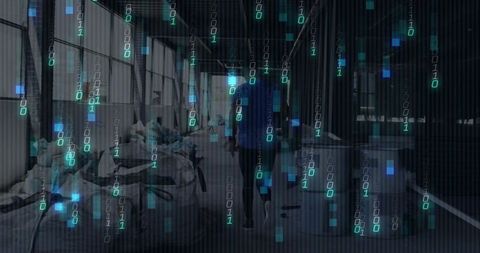 Blue-shirt warehouse worker walking down industrial aisle with binary data overlay