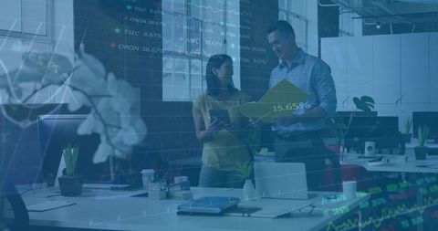 Colleagues Reviewing Stock Charts in Modern Office Setting