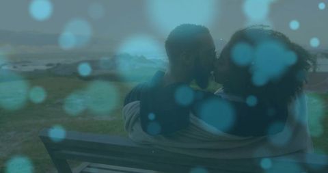 Romantic Couple Snuggling by Shore with Dreamy Bokeh Effect