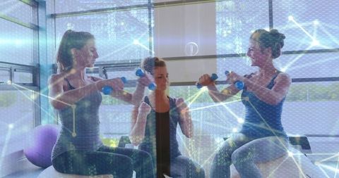 Group Exercise with Dumbbells and Technology Overlay in Modern Gym