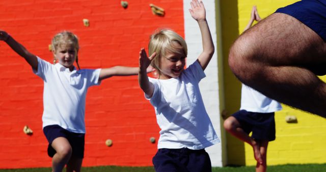 Kids Practicing Yoga Outdoors on Colorful Playground Wall - Download Free Stock Images Pikwizard.com