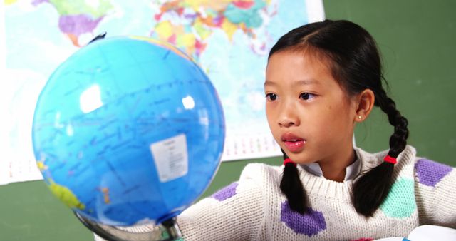 Curious Schoolgirl Exploring Geography with Globe - Download Free Stock Images Pikwizard.com