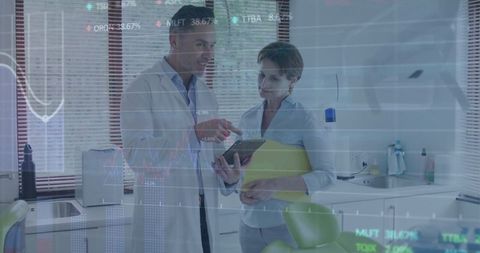 Dentists Analyzing Digital Charts in Modern Clinic