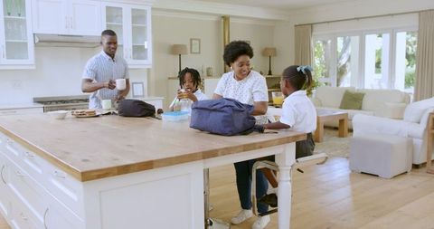 Family Morning Routine Packing School Bags in Kitchen