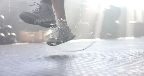 Athletic Man Jumping Rope with Digital Overlay in Gym