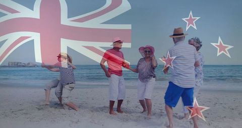 Senior adults dancing on new zealand beach with flag overlay and sun hats