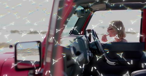 Elegant Woman Preparing for Beach Day in Red Convertible
