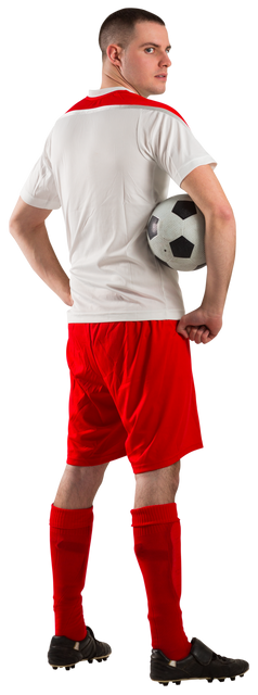 Young football player in red and white uniform holding soccer ball during practice - Download Free Stock Videos Pikwizard.com