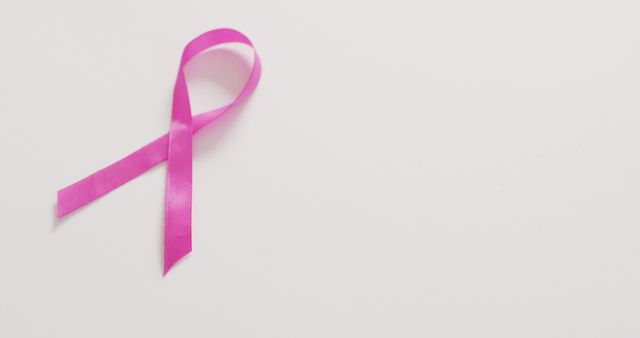 Image of pink breast cancer ribbon on white background. medical and healthcare awareness support campaign symbol for breast cancer.
