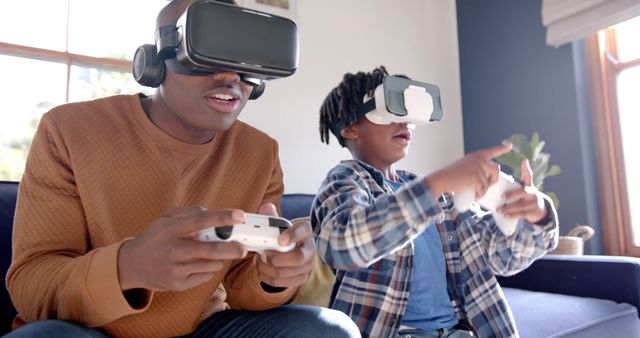 Father and Son Engaged in Virtual Reality Gaming Adventure - Download Free Stock Images Pikwizard.com