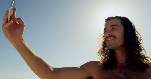 Smiling Young Man Taking Selfie on Sunny Day at Beach - Download Free Stock Images Pikwizard.com