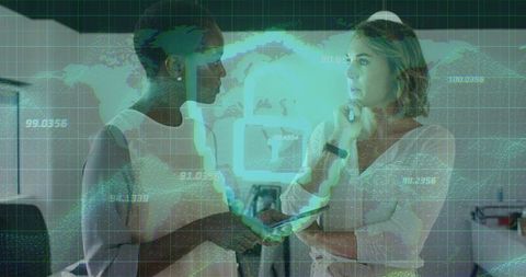 Two Women Collaborating on Digital Technology in Modern Professional Office