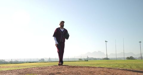 Baseball player standing on mound with glove