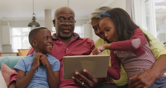 Grandparents Spending Quality Time with Grandchildren Using a Digital Tablet - Download Free Stock Images Pikwizard.com