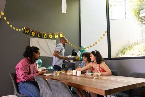 Family Gathering for Warm Home Celebration with Welcome Banner