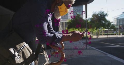 Urban commuter using smartphone on bicycle for connectivity