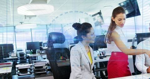 Two Businesswomen Collaborating at Open-Plan Office with Digital HUD Data Analytics Overlay