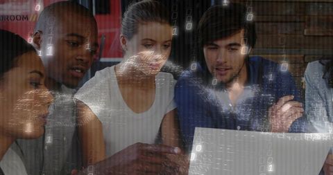 Team collaborating around laptop with digital binary overlay and data visualization