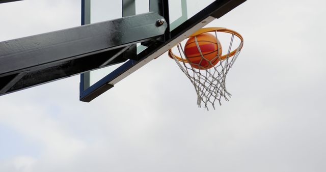 Basketball Going Through Hoop Outdoors - Download Free Stock Images Pikwizard.com