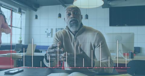 Businessman Analyzing Data in Office with Graph Overlay