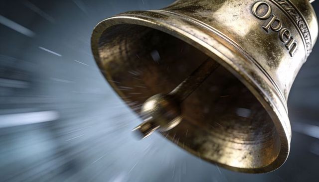 Antique brass bell ringing with visible clapper and open inscription, dramatic motion blur