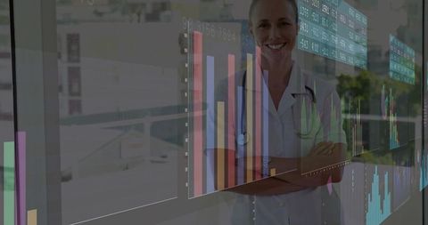 Smiling Doctor Reviewing Data Charts in Glass Corridor