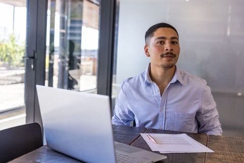 Professional reviewing document in modern office environment