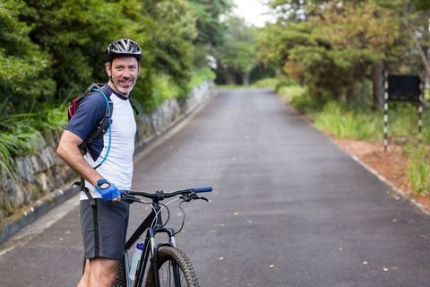 Middle-Aged Cyclist on Forest Trail with Mountain Bike and Helmet - Download Free Stock Images Pikwizard.com