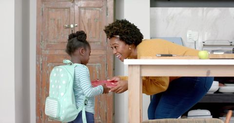Joyful mother and daughter in morning school routine