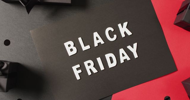 Black friday text in white on black with black gift boxes on red and black background. Luxury treat, present, shopping, black friday sale and retail concept digitally generated image.