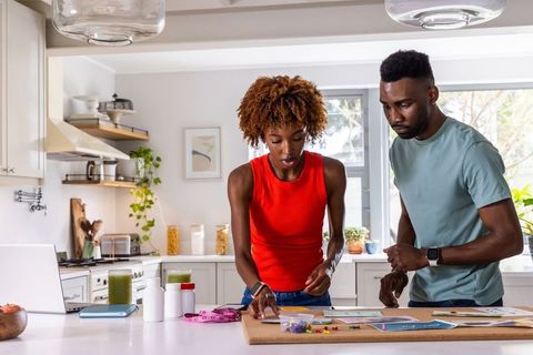 Couple collaborating on diy home craft project at bright modern kitchen island