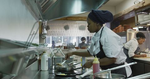 Chefs Creating Dishes in Busy Restaurant Kitchen