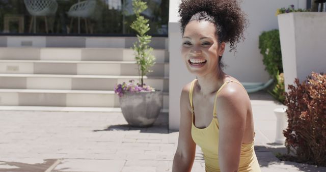 Smiling Woman in Yellow Outfit Sitting Outdoors on a Sunny Day - Download Free Stock Images Pikwizard.com