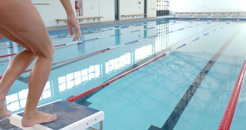 Swimmer Poised for Dive at Indoor Pool, Race Anticipation - Download Free Stock Images Pikwizard.com