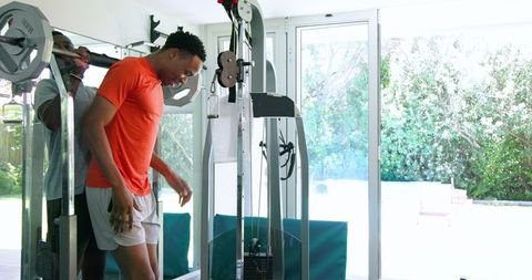 African American Man Weightlifting in Modern Home Gym