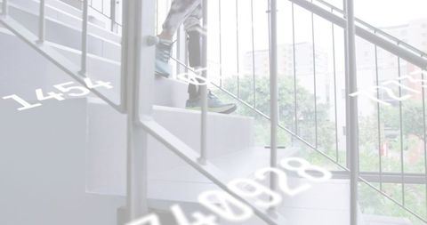 Senior professional climbing glass staircase with briefcase, sneakers and data overlay