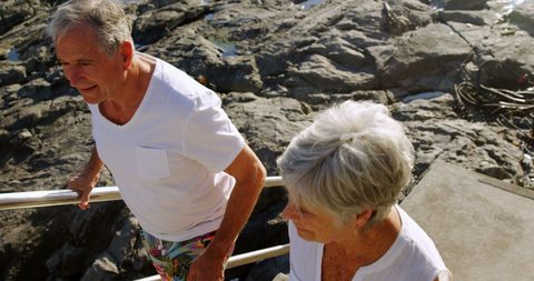 Happy Senior Couple Strolling by Seaside