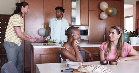 Friends Enjoying Dining Experience in Modern Kitchen Setting