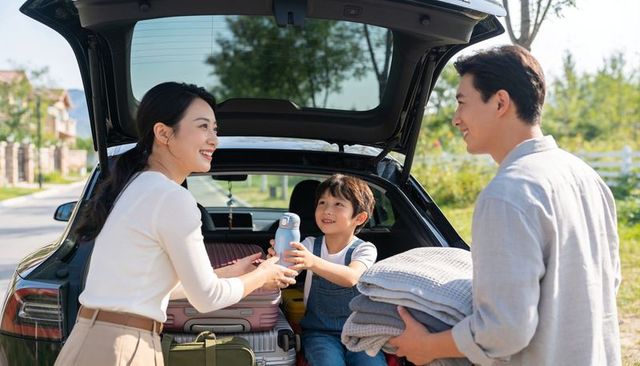 Family packing suv trunk for weekend road trip handing water bottle to smiling child sunny