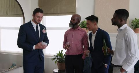 Groom Sharing Emotional Speech with Friends at Wedding Gathering