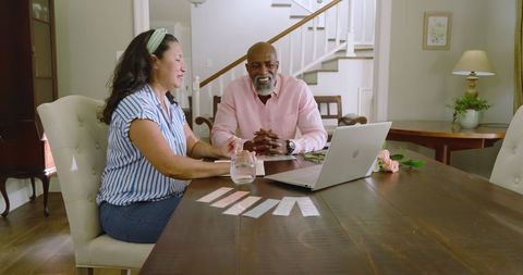 Mature Couple Discussing Home Renovation Plans at Dining Table