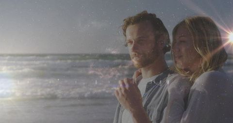 Romantic Couple Enjoying Tranquil Beach at Sunset with Gentle Waves