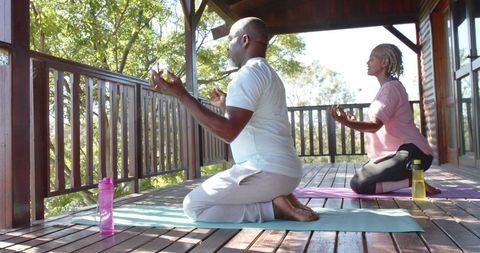 Senior African American Couple Meditating on a Porch