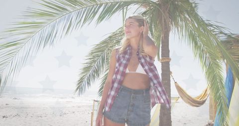 Woman Enjoying Breeze on Beach with American Flag Overlay