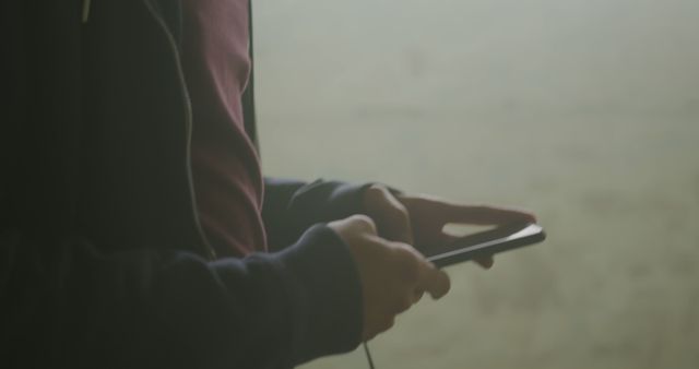 Person Using Smartphone Indoors in Calm Natural Light - Download Free Stock Images Pikwizard.com